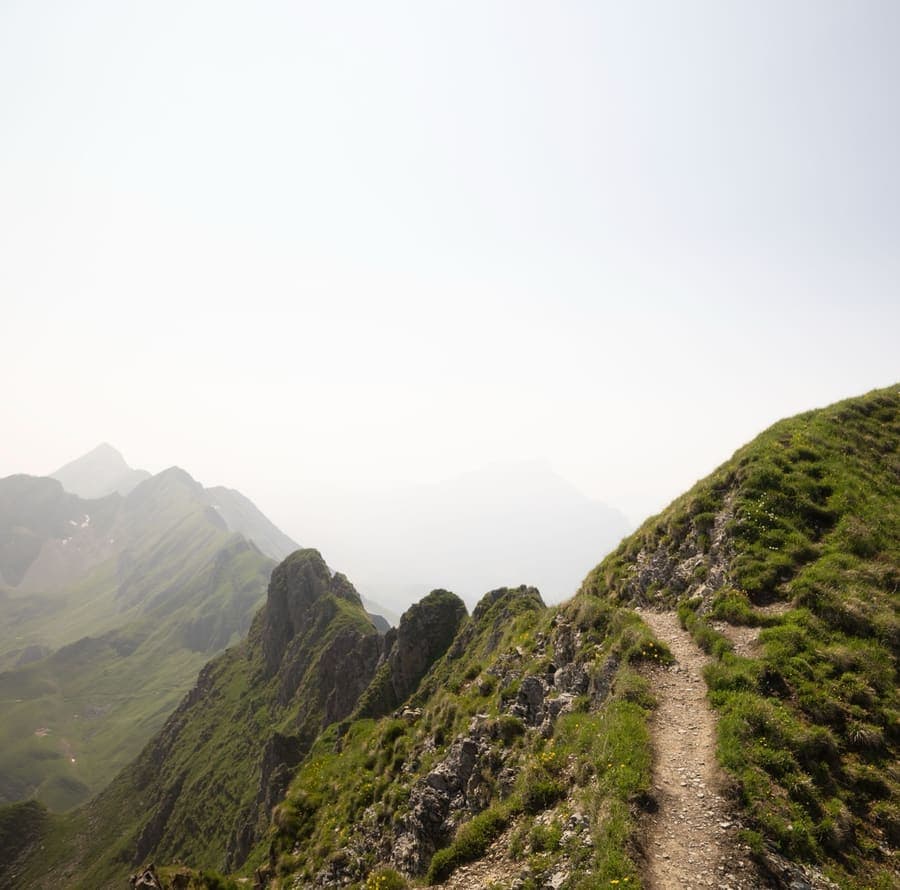 Narrow grassy ridgeline above a lake