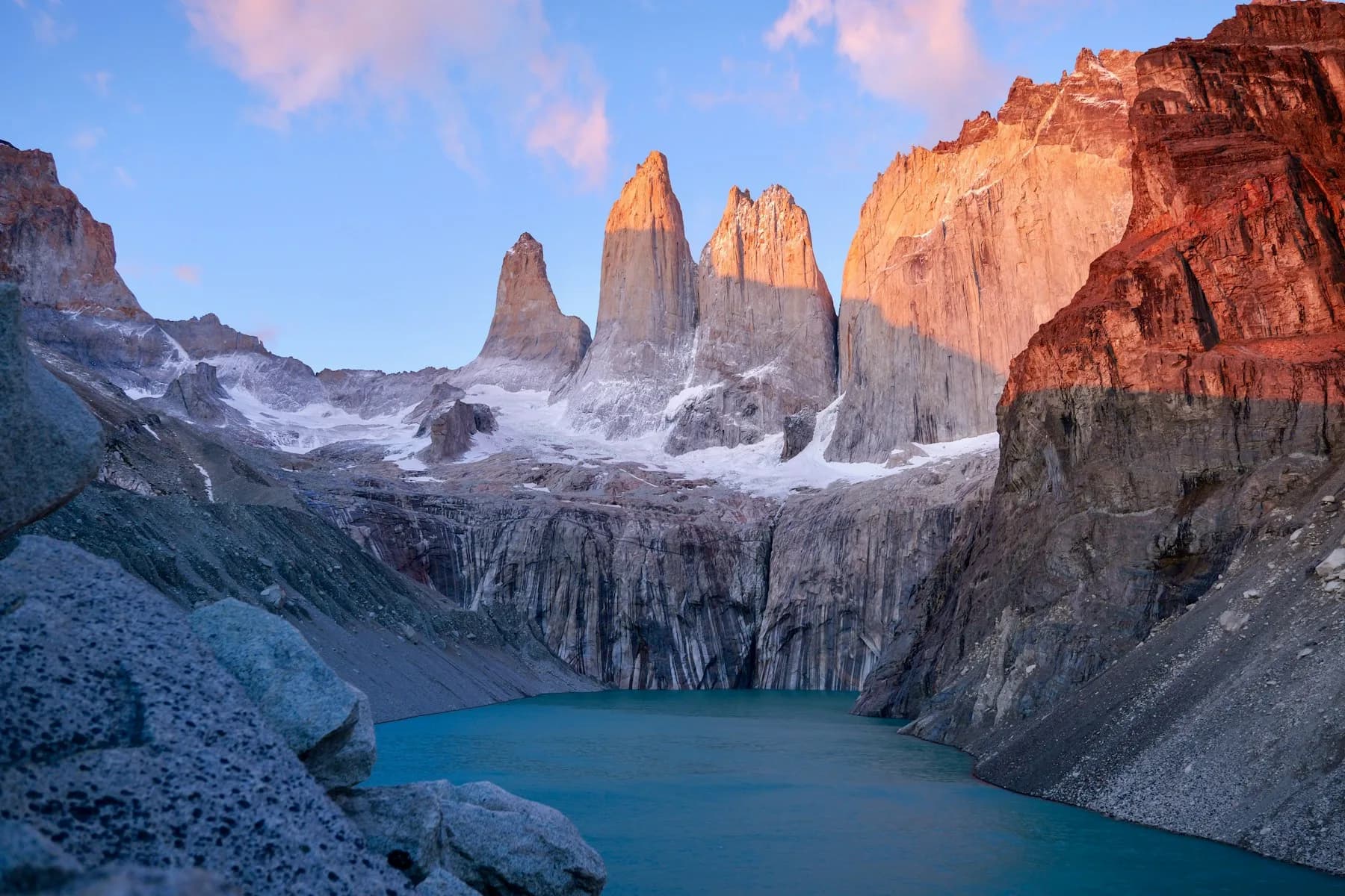 The three granite towers of Torres del Paine above their glacial lake at sunrise