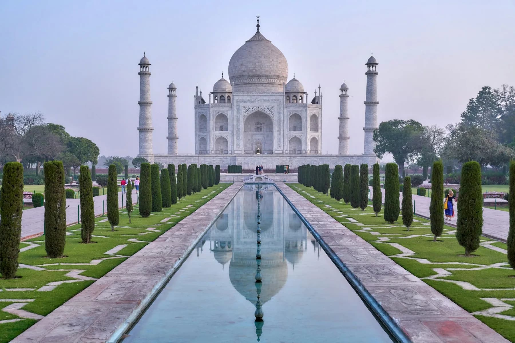 The Taj Mahal mirrored in the long water channel of its garden